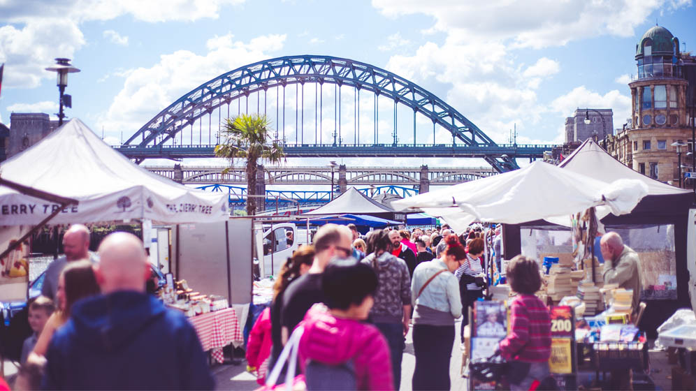 Shoppers look at market stalls at the weekly Quayside Market